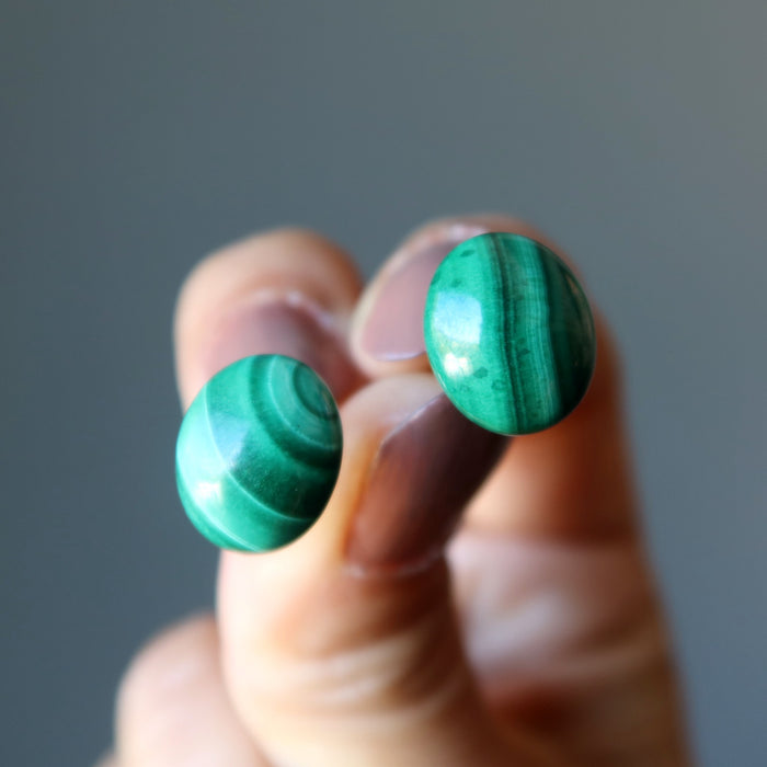 hand holding malachite stud earrings