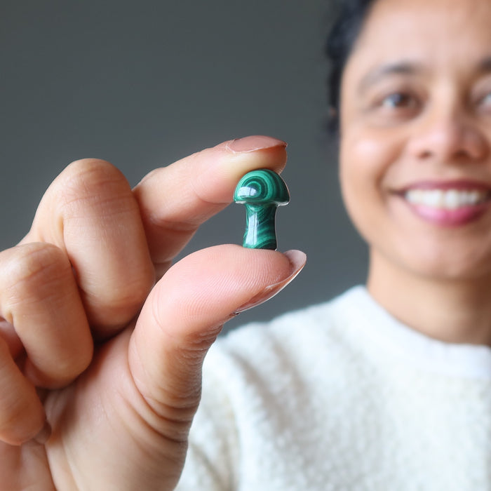 woman holding malachite mushroom