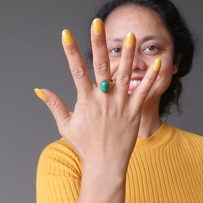 sheila of satin crystals wearing green oval malachite in gold adjustable ring