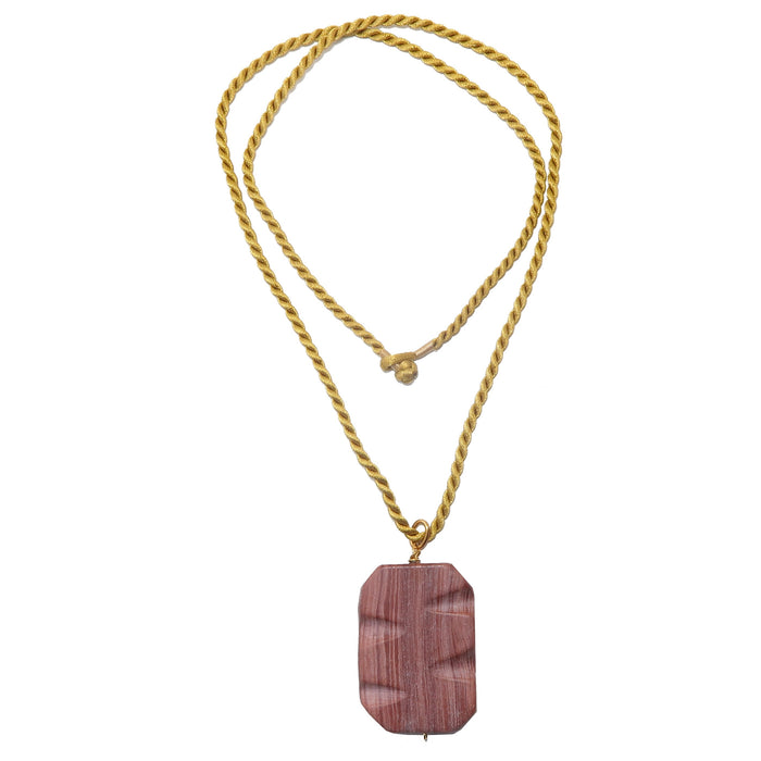 A rectangular marble pendant wrapped in gold-tone wire and attached to a satin-coated nylon twist cord necklace.