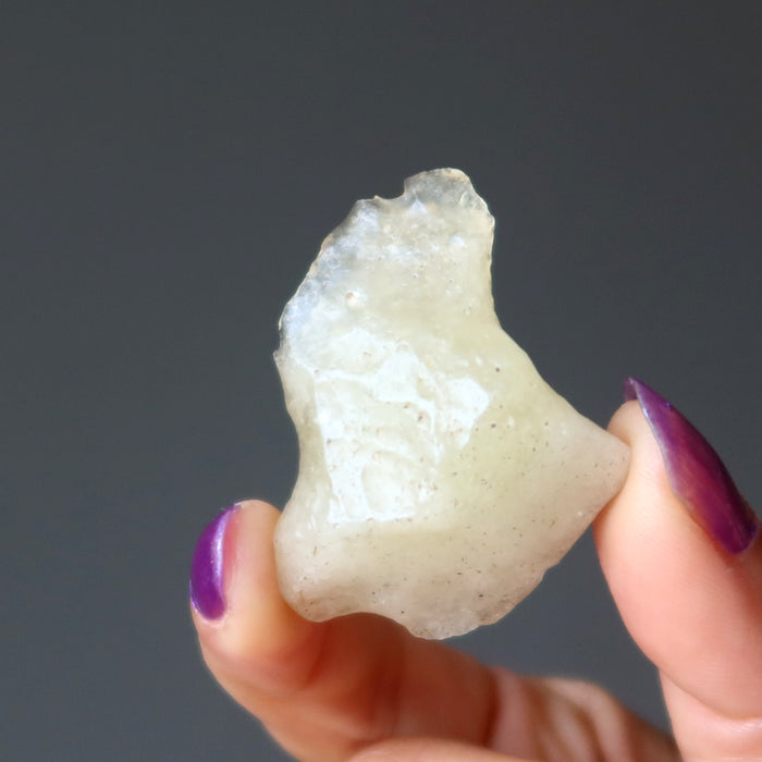 hand holding yellow libyan desert glass rough tektite