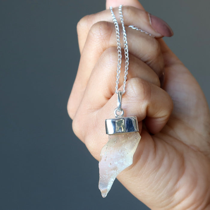 hand holding libyan desert glass necklace