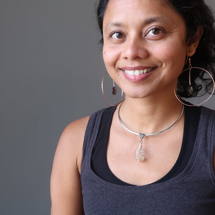 sheila of satin crystals wearing raw yellow libyan desert glass in silver cage choker necklace and mica hoop earrings