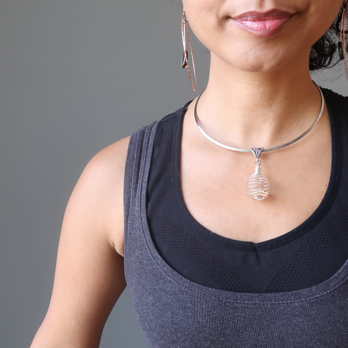 raw yellow libyan desert glass in silver cage choker necklace on female neck