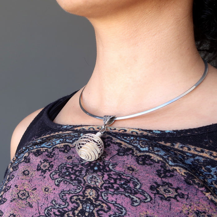 raw yellow libyan desert glass in silver cage choker necklace on female neck