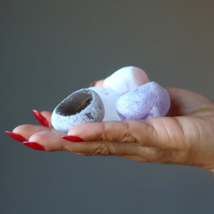 hand holding smoky quartz, clear quartz, amethyst, rose quartz picture windows