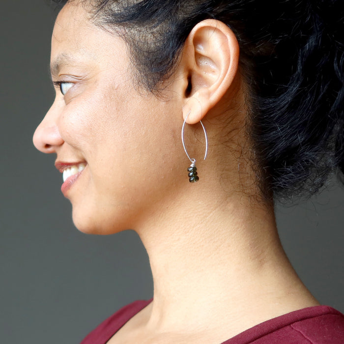 sheila of satin crystals wearing moldavite earrings