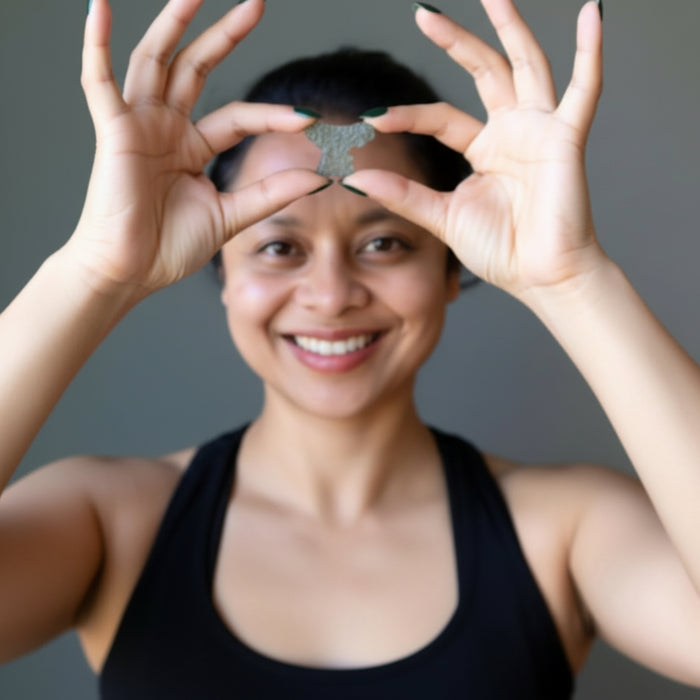 sheila of satin crystals holding raw moldavite 