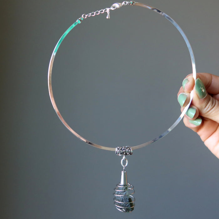 hand holding moldavite choker necklace