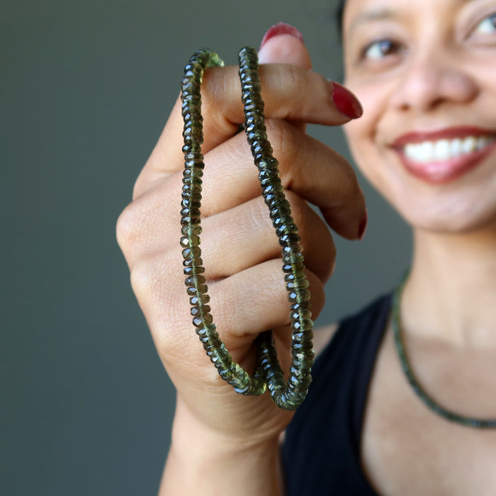 hand holding moldavite necklace
