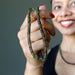 hand holding moldavite necklace