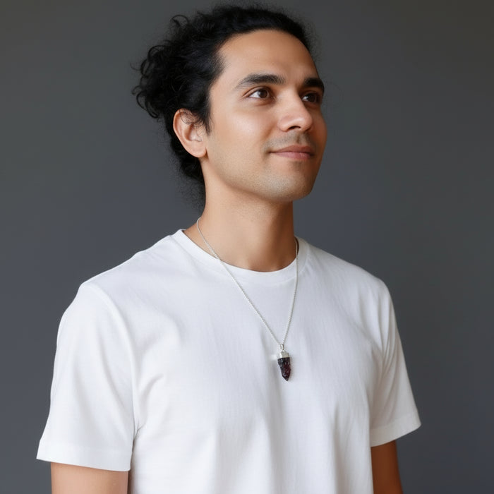 man wearing moldavite necklace