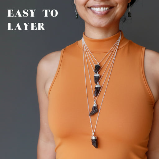 woman wearing 5 moldavite necklaces