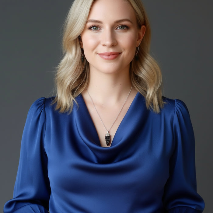 woman wearing a moldavite necklace and earrings