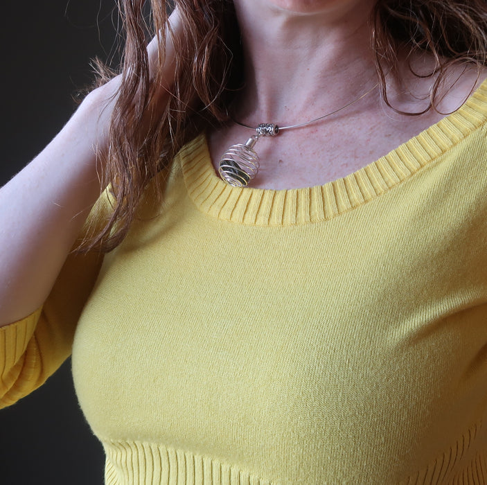 moldavite cage necklace on female