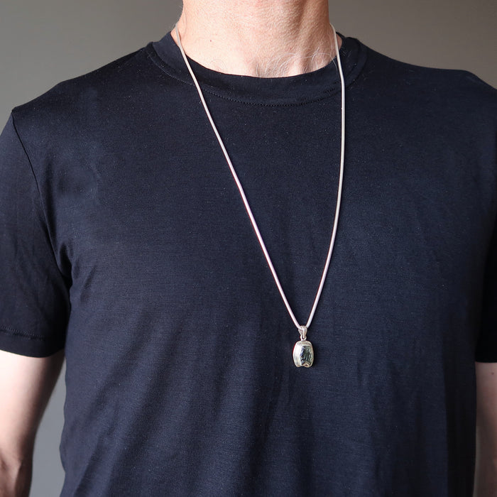 male model wearing a moldavite necklace