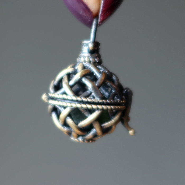 hand holding a meteorite pendant