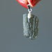 hand holding moldavite pendant