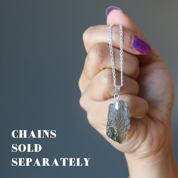 hand holding moldavite necklace