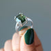 hand holding moldavite ring