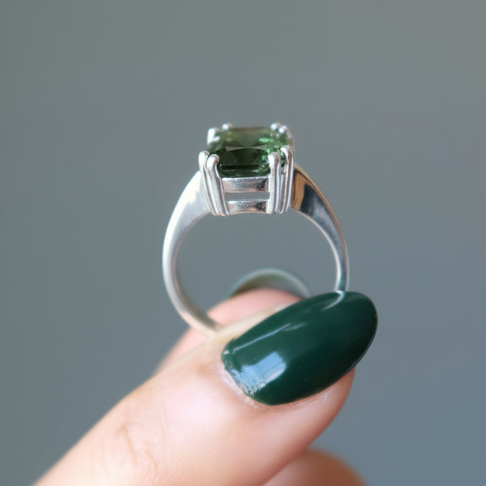 hand holding moldavite ring