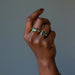hand wearing 2 moldavite ring on fingers