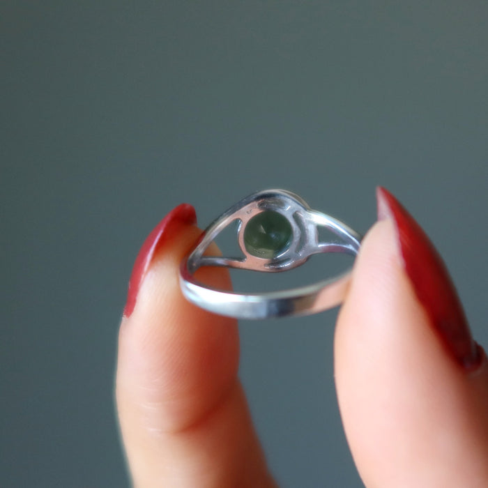 hand wearing a moldavite faceted ring on the finger