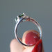 hand holding a moldavite faceted ring on the finger
