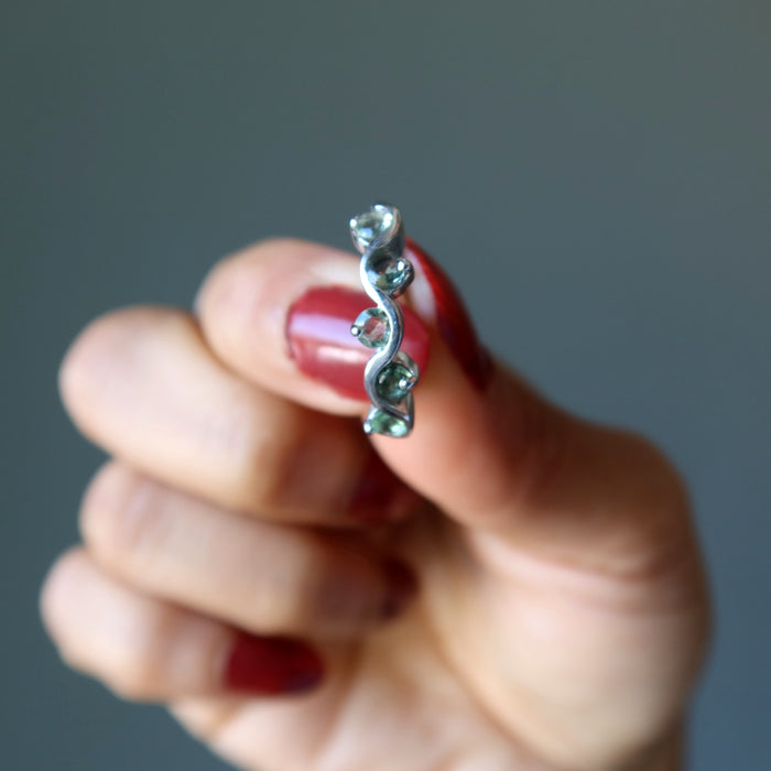 hand holding moldavite ring