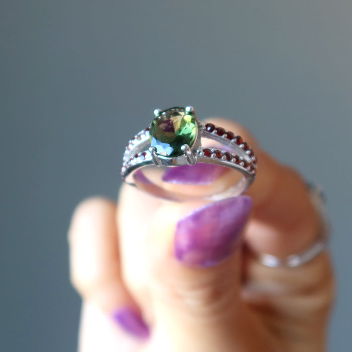 hand holding moldavite garnet