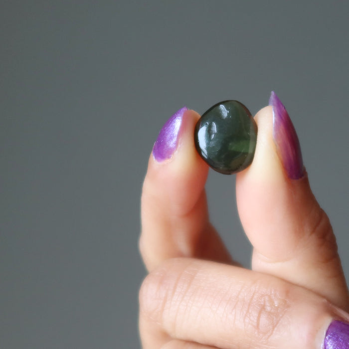 hand holding moldavite stone