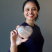 woman holding peach moonstone heart
