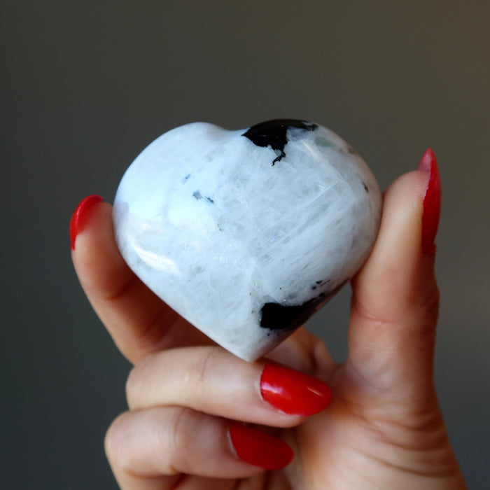 hand holding moonstone tourmaline heart