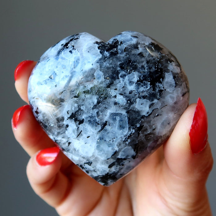 hand holding moonstone tourmaline heart