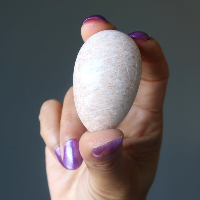 hand holding Cream Moonstone Egg 
