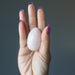 hand holding Cream Moonstone Egg 