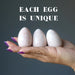 three Cream Moonstone Eggs on model palm each is unique