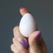 hand holding Cream Moonstone Egg 
