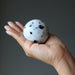  moonstone tourmaline sphere in palm of hand