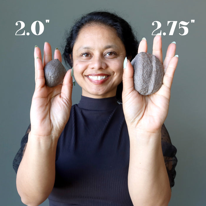 sheila of satin crystals holding two moqui marbles