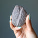hand holding a natural moqui stone