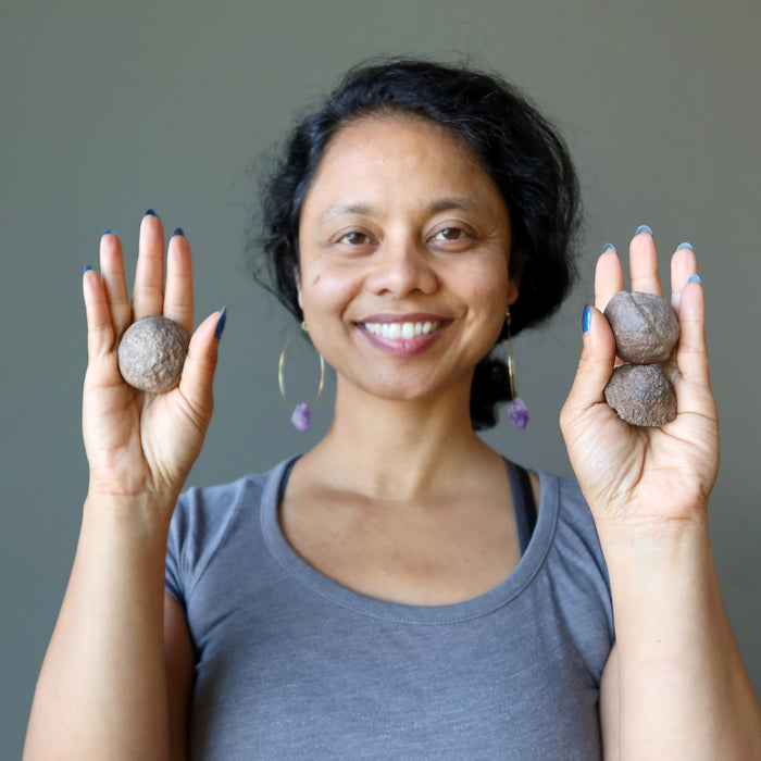 sheila of satin crystals two male and one female moqui marble stones in varying sizes in her palms