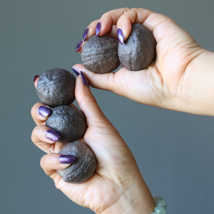 hands holding set of 5 brown moqui marble stones large