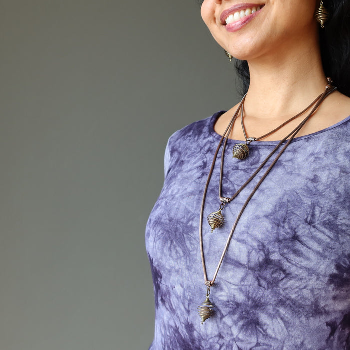 female wearing moqui marble stone in vintage cage on antique copper snake chain necklaces