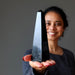 woman holding black obsidian obelisk