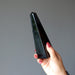 hand holding black obsidian obelisk