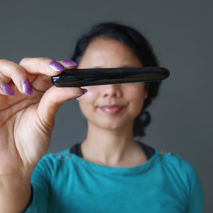 sheila of satin crystals holding a black obsidian wand