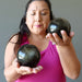 female model holding Gold Sheen Obsidian Sphere one on each hand