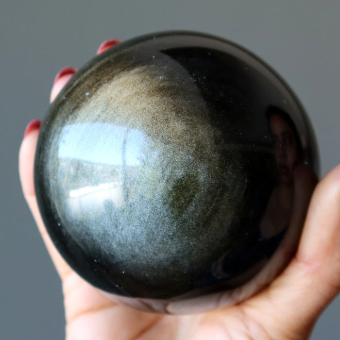 holding Gold Sheen Obsidian Sphere