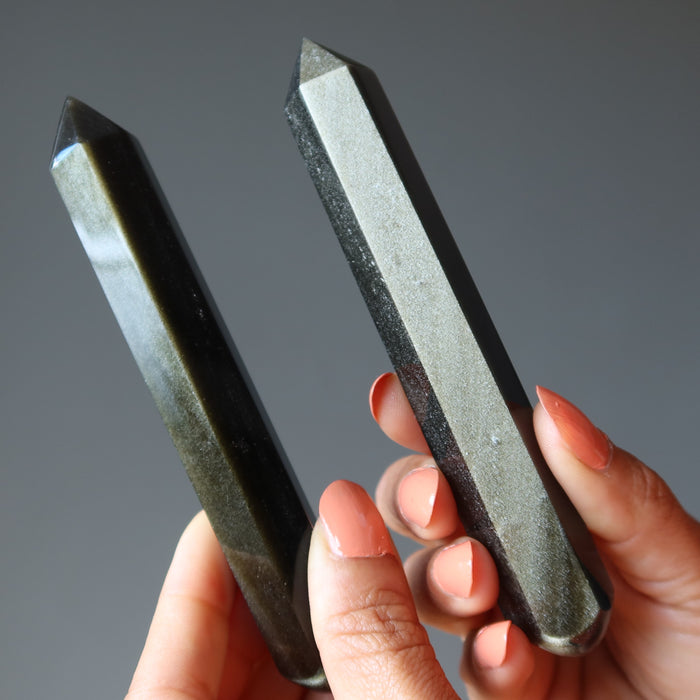 hands holding two Faceted Gold Sheen Obsidian Wands